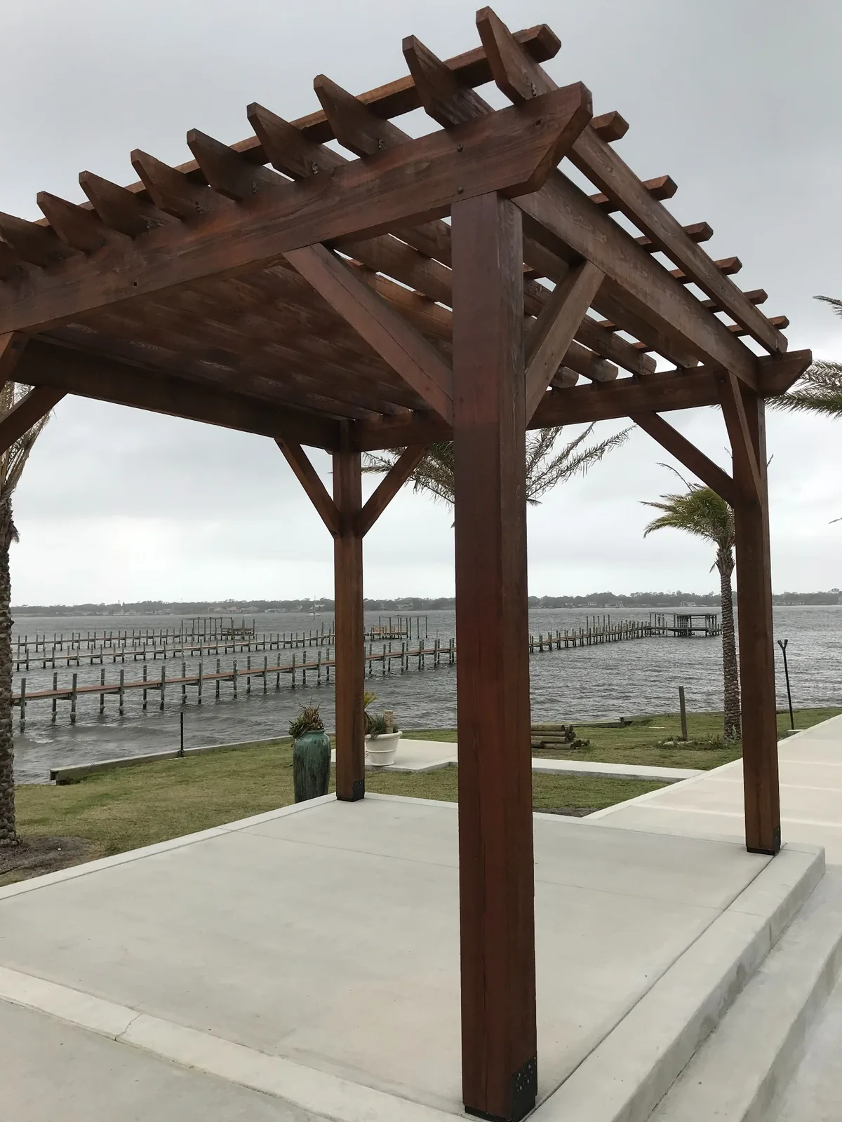 Timber pergola overlooking the water by Cypress Building Group